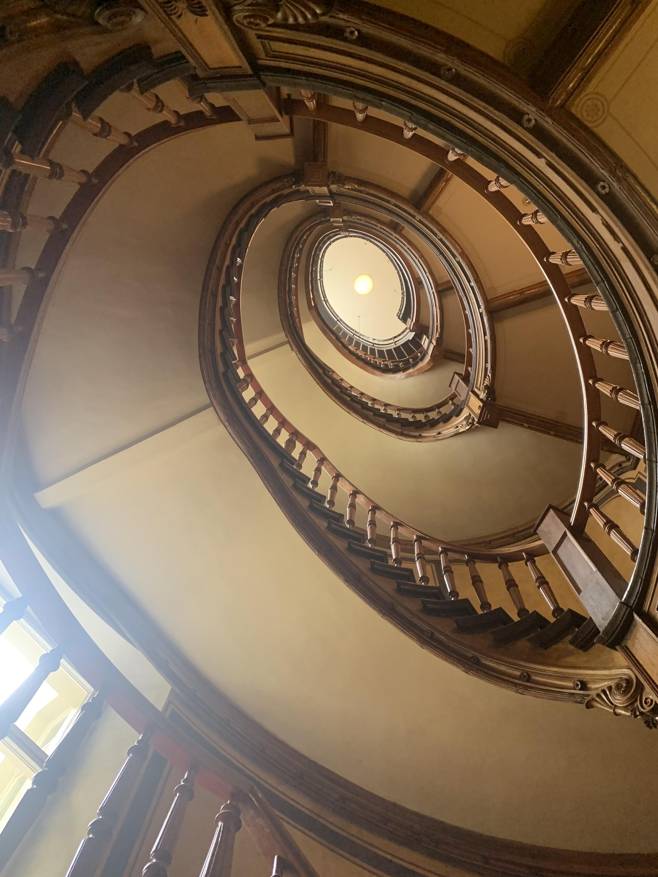 portal of spiral staircase with wooden bannisters & railings in berlin