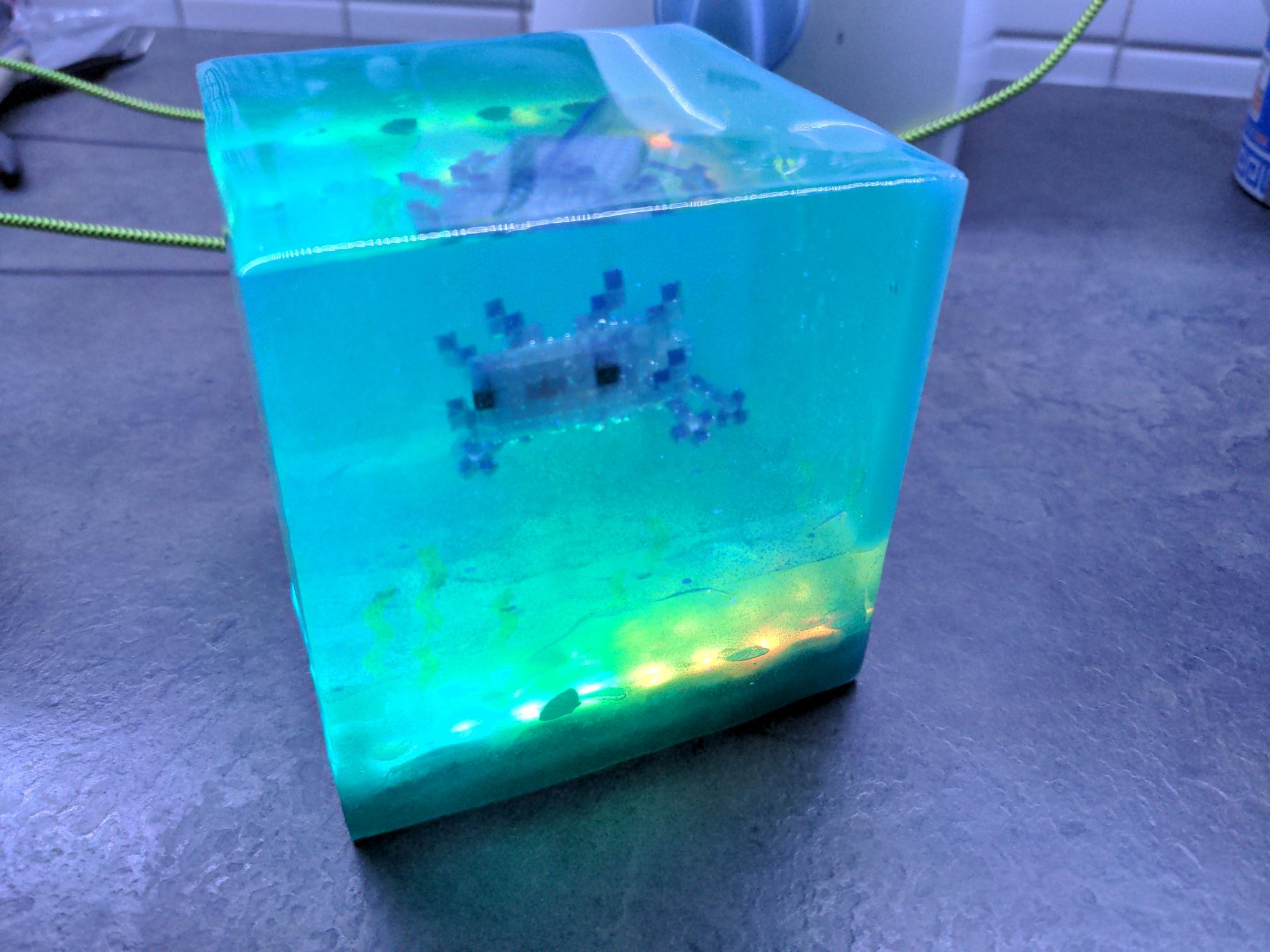 front view of the axolotl in a light environment. the purple axolotl is clearly visible and the sea floor is glowing green yellow
