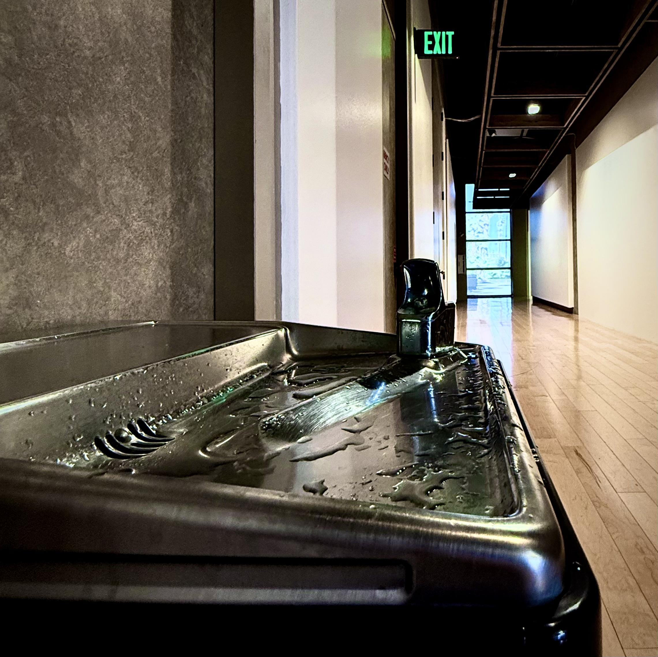 Drinking fountain in a long hall in an art museum