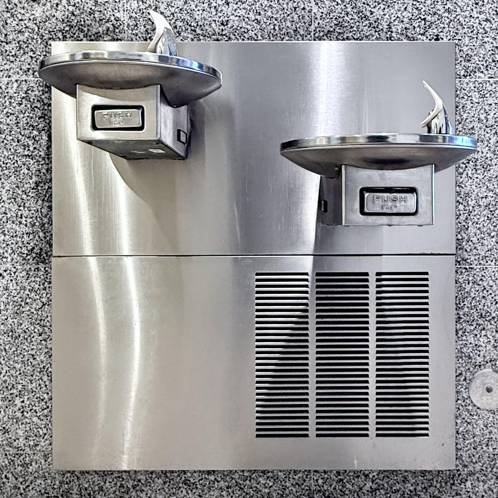 Drinking fountains on a grey wall