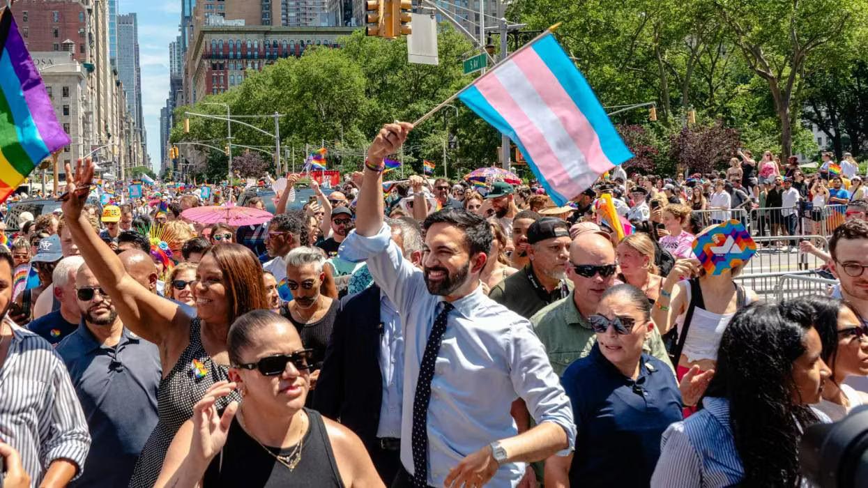 Zohran Mamdani marching at pride waving a trans flag over his head like the based BAMF he is. 