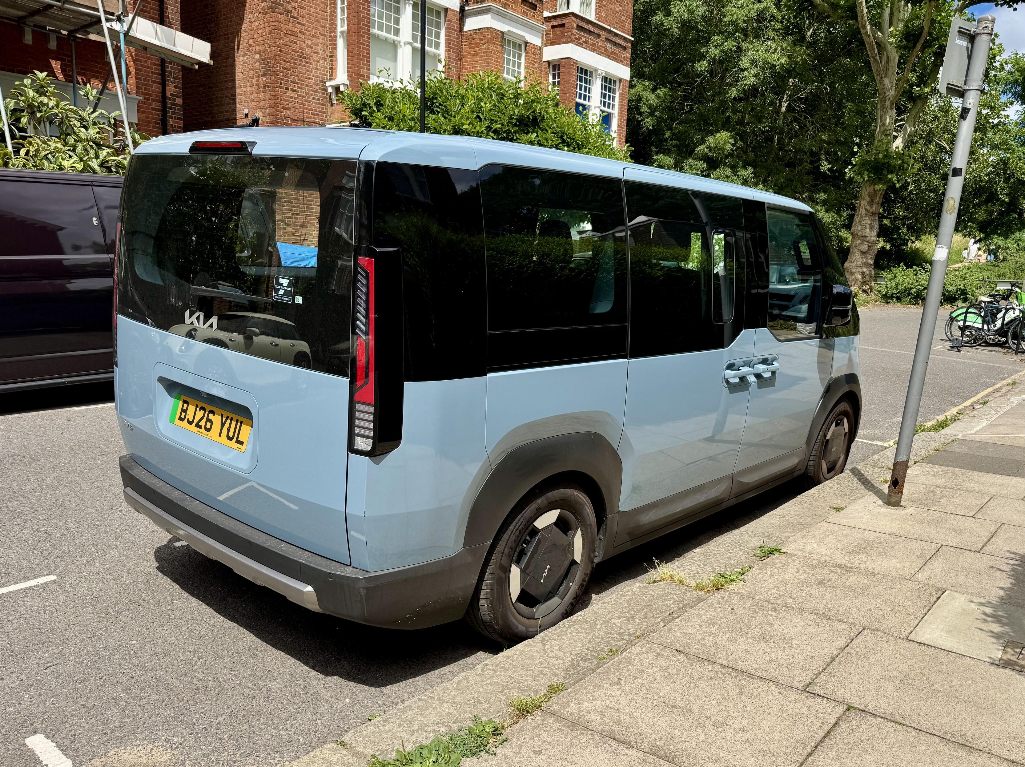 Cool light blue kia van parked on narrow London street