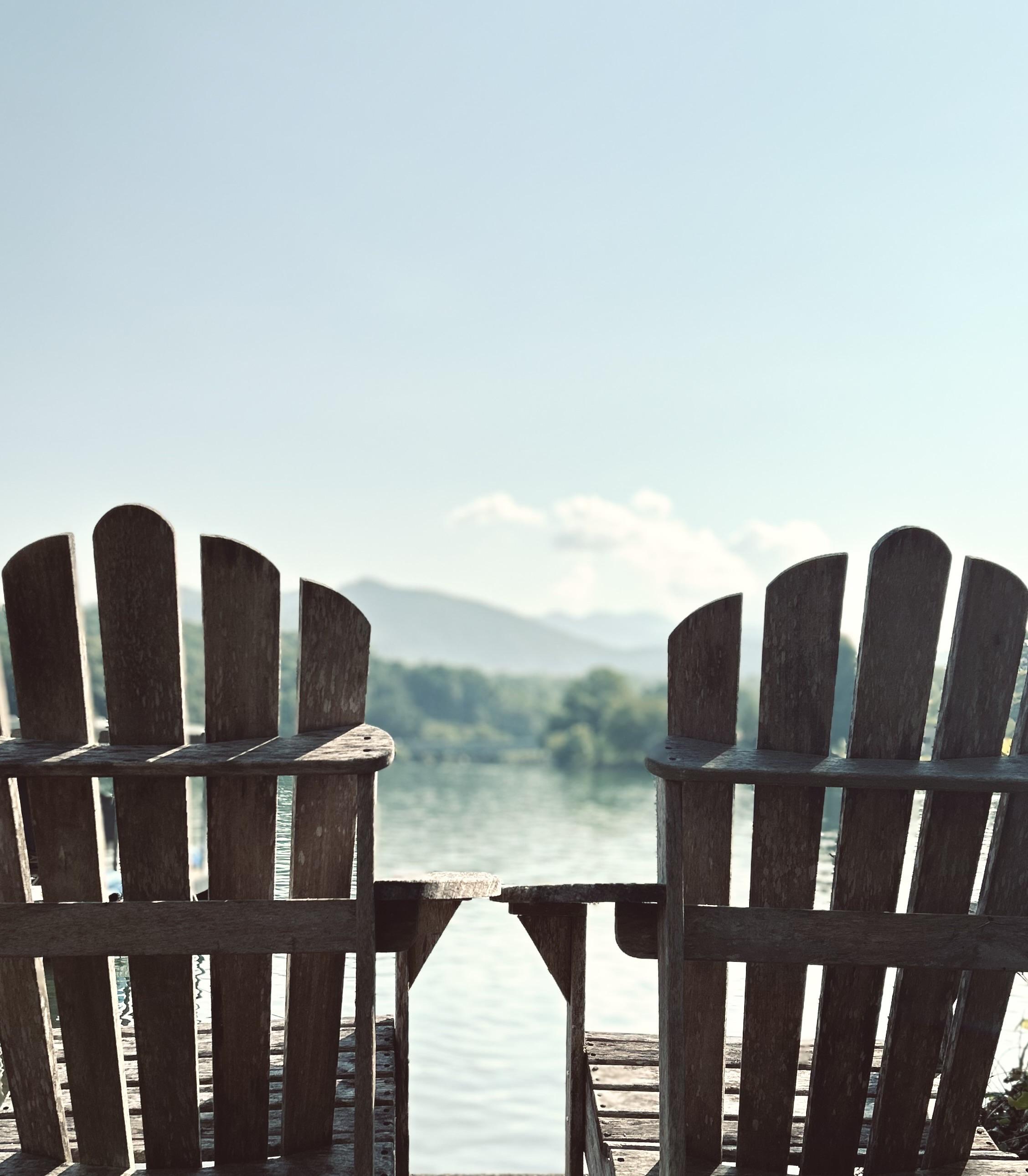 A favorite view of mine at Lake Chatuge, the back of two Adirondack chairs facing the lake.
