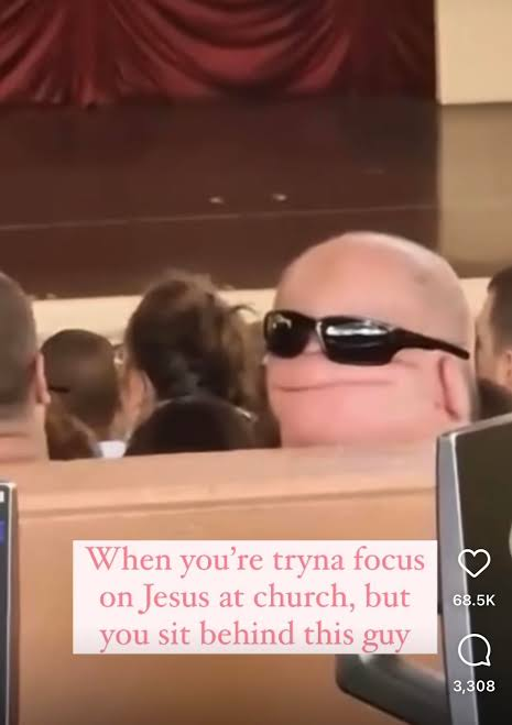 A bald dude with his sunglasses on the back of his head.