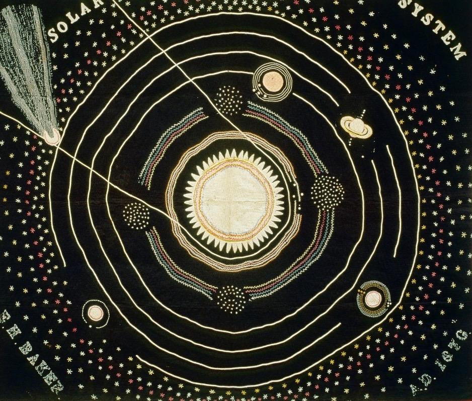 Black quilt showing sun at center of a simplified solar system. In the corner, a comet.